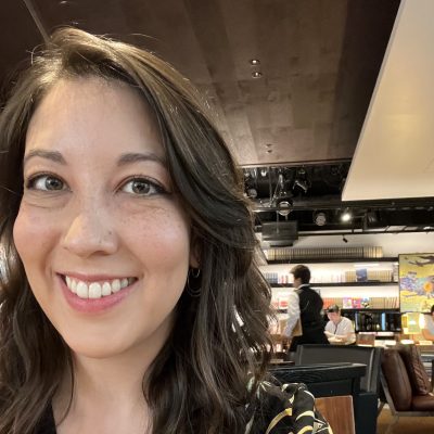 Headshot of Amelia Ino inside a cafe.