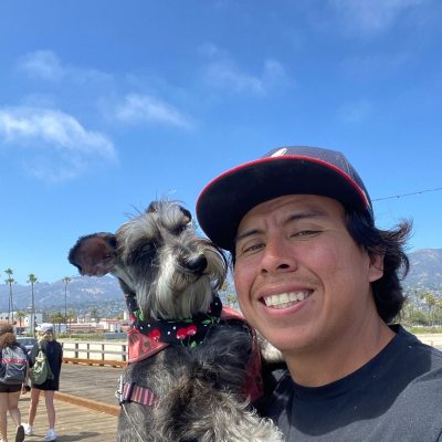 Moises Machuca poses with Dido, his miniature schnauzer.