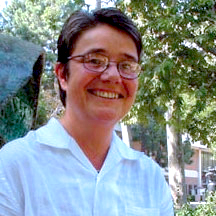 Headshot of Kirstie McClure in a white button down shirt.